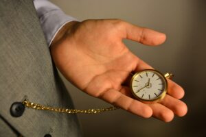 A salesperson checking a pocket watch