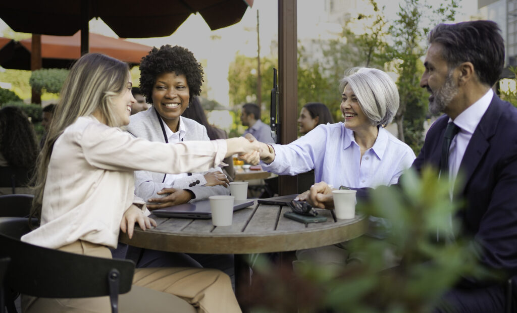A team of brand awareness strategists meeting a loyal customer